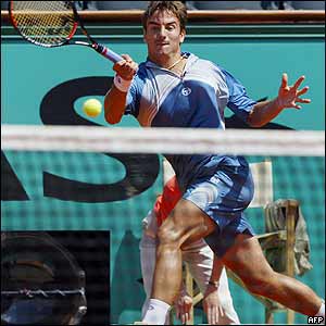 Spain's Tommy Robredo returns the ball to compatriot Albert Costa in their quarter-final match 