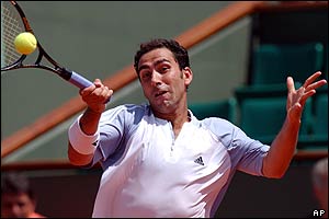 Defending champions Spain's Albert Costa returns the ball to compatriot Tommy Robredo 