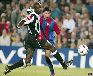 Juventus' Lillian Thuram tries to stop Barcelona's Javier Saviola 