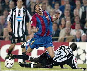 Barcelona's Michael Reiziger is challenged by Juventus' Lillian Thuram 