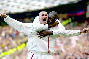 David Beckham celebrates his goal against Greece with Emile Heskey