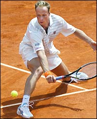 Martin Verkerk stoops to play a low volley