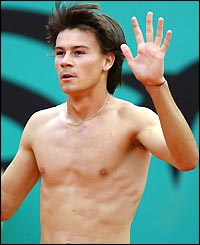 Guillermo Coria shows his bare chest after giving his shirt to a ball girl as an apology for hitting her with his racket