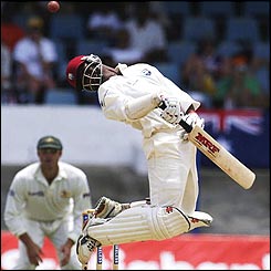 Brian Lara jumps to avoid a bouncer from Brett Lee