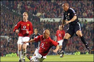 Real Madrid's Ronaldo scores his hat trick goal against Manchester United as Wes Brown slides on to tackle 