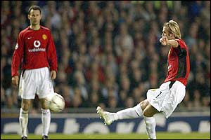 Manchester United's David Beckham scores with a free-kick against Real Madrid