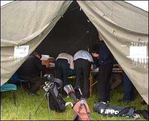 Golfers in scorer's tent