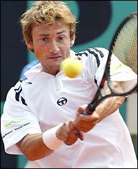 Juan Carlos Ferrero hits a backhand return during the final