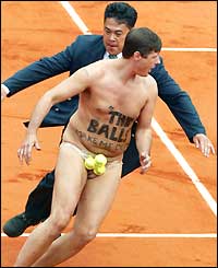 Security guards chase a streaker off the court