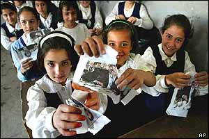 Kirkuk children tear up pictures of Saddam Hussein