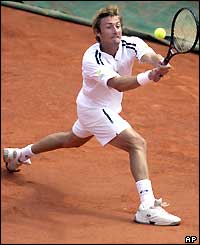 Juan Carlos Ferrero reaches to play a backhand