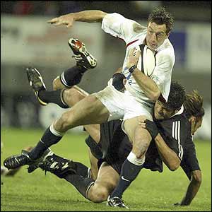 England wing Dan Luger is tackled by New Zealand Maori Taine Randell