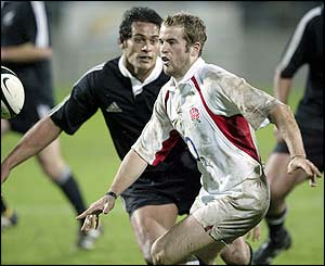 England winger James Simpson-Daniel offloads the ball to a team-mate