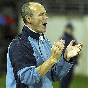 England coach Clive Woodward applauds the players from the pitch after the 23-9 win