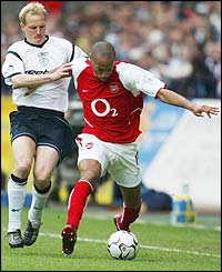 Bolton midfielder Per Frandsen tracks the run of Arsenal striker Thierry Henry