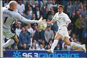 Blackburn keeper Brad Friedel blocks Harry Kewell's shot but Mark Viduka puts in the rebound