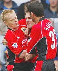Damien Duff and Hakan Sukur congratulate Blackburn goalscorer David Dunn (centre)