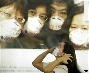 A woman puts on a mask in Hong Kong