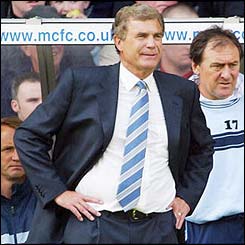 West Ham interim boss Trevor Brooking watches the action unfold at Maine Road