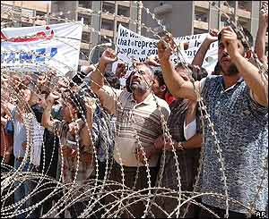 Shia demonstrators gather outside the conference venue