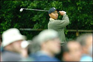 Tiger Woods takes a shot as the crowd at Olympia Fields look on