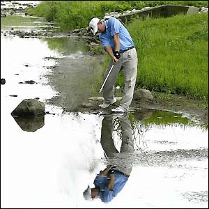 John Bradley Holmes plays his way out of the creek at the US Open