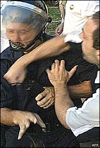 A Sljivancanin supporter hits a policeman 