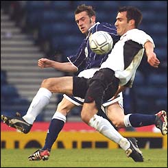 James McFadden puts a foot in as he tries to win the ball against Austria
