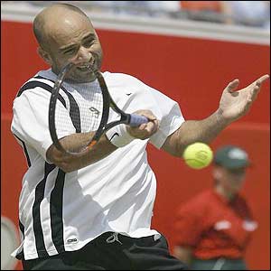 Andre Agassi powers a forehand to Andy Roddick