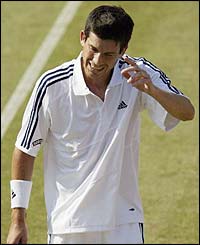 Henman reacts after winning a point