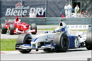 Ralf Schumacher's Williams leads brother Michael's Ferrari after lap two