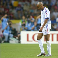 Thierry Henry hangs his head as he walks from the pitch after being sent off against Uruguay