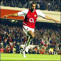 Thierry Henry celebrates scoring against Manchester United