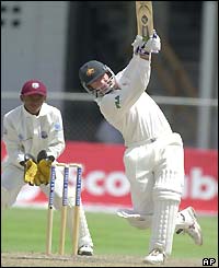 Andy Bichel smashes a drive to the boundry