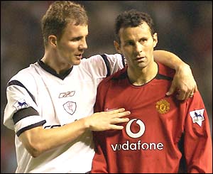Bolton's Gudni Bergsson consoles Ryan Giggs in defeat