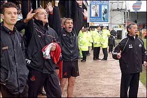 Swansea's management and staff hear the final whistle which signals survival for the Swans.