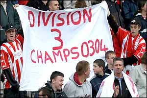 Cheltenham fans wave a banner after relegation