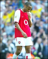 A dejected looking Thierrry Henry trudges off the pitch