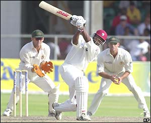 Brian Lara drives the ball to the boundary on his way to an unbeaten 41 by close of play
