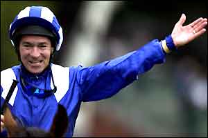 Jockey Richard Hills celebrates after winning the Prince of Wales Stakes