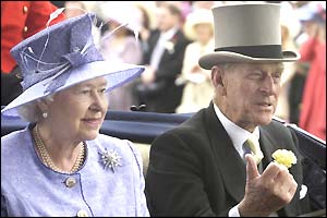 The Queen and Duke of Edinburgh ride down the Ascot course in an open-topped carriage