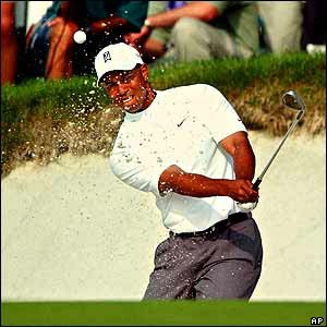 Tiger Woods plays a clever shot to get out of the bunker as he takes part in the Buick Classic in New York 