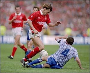 Nottingham Forest's Teddy Sheringham is tackled by Steve Bruce of Manchester United during a match at the City Ground