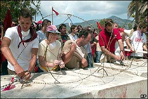 Members of Greek Communist Party remove barbed wire from beach near Porto Carras