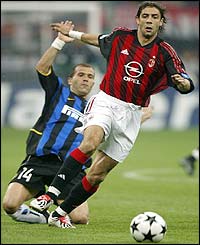 AC Milan's Rui Costa is tackled by Inter's midfielder Luigi di Biagio