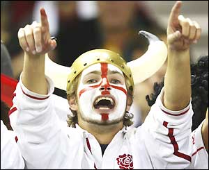 An England fan sings and holds his arms aloft as he cheers his team on