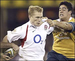 Josh Lewsey attacks as an Australian defender tries to pull him back