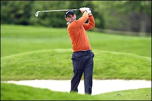 Paul McGinley of Ireland drives out of a bunker on 17