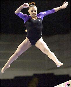 Tasha Schwikert performs on the beam