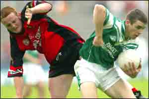 CDown fowrward Beny Coulter (left) and Fermanagh's Colm Bradley